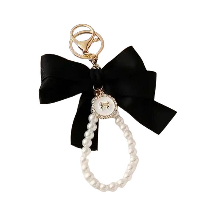 Black ribbon bow bag charm with a faux pearl loop and gold clasp