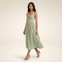 Sunoire emilia sage stretch cotton halter neck midi dress walking 01