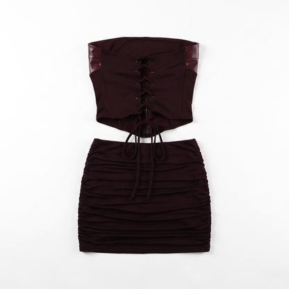 Sunoire fashionable hollow out bodycon strapless backless tube top mini pleated skirt leather pu 2 piece women set garment flatlay 01