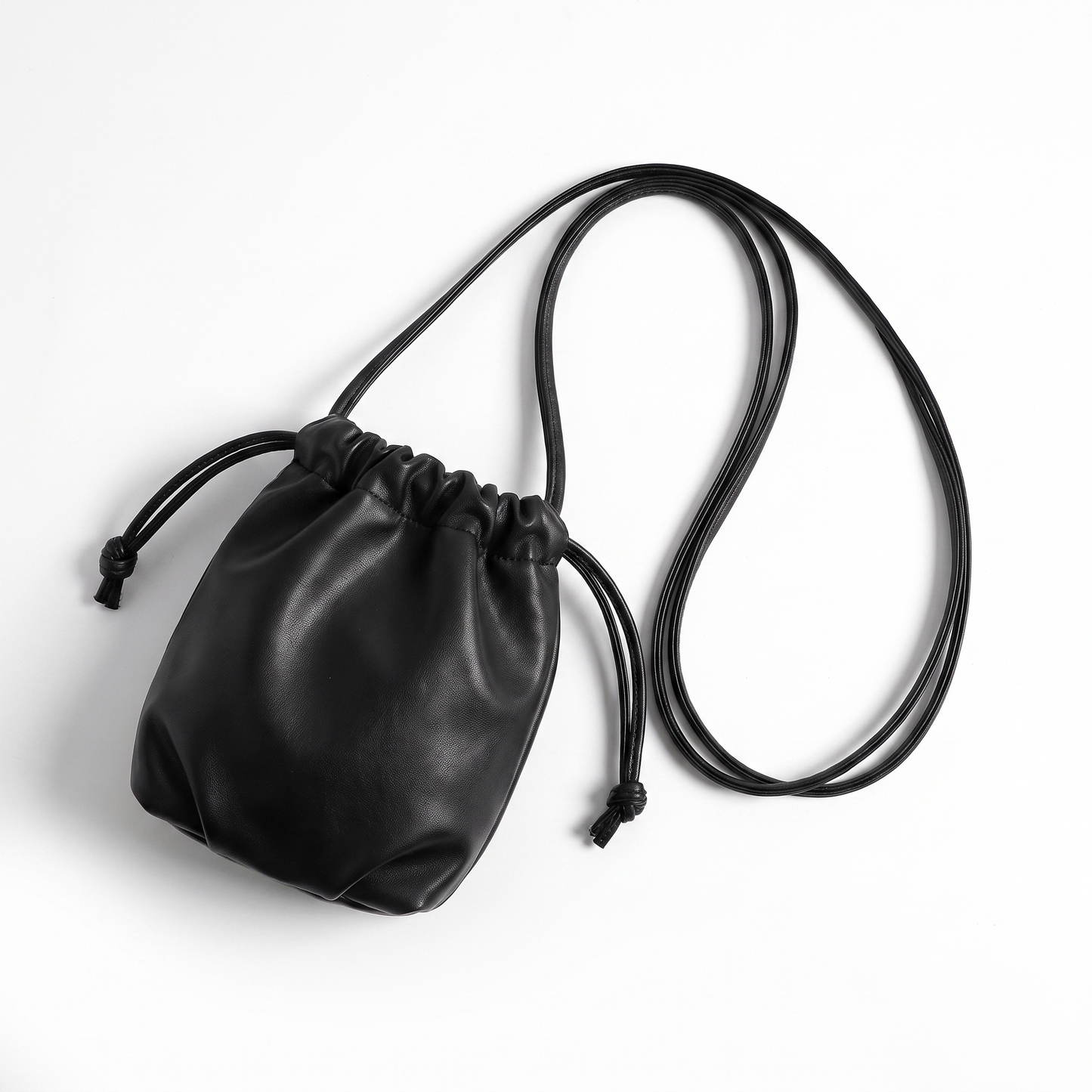 Sunoire mira black drawstring bucket bag garment flatlay 01