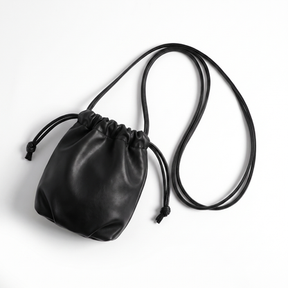 Sunoire mira black drawstring bucket bag garment flatlay 01