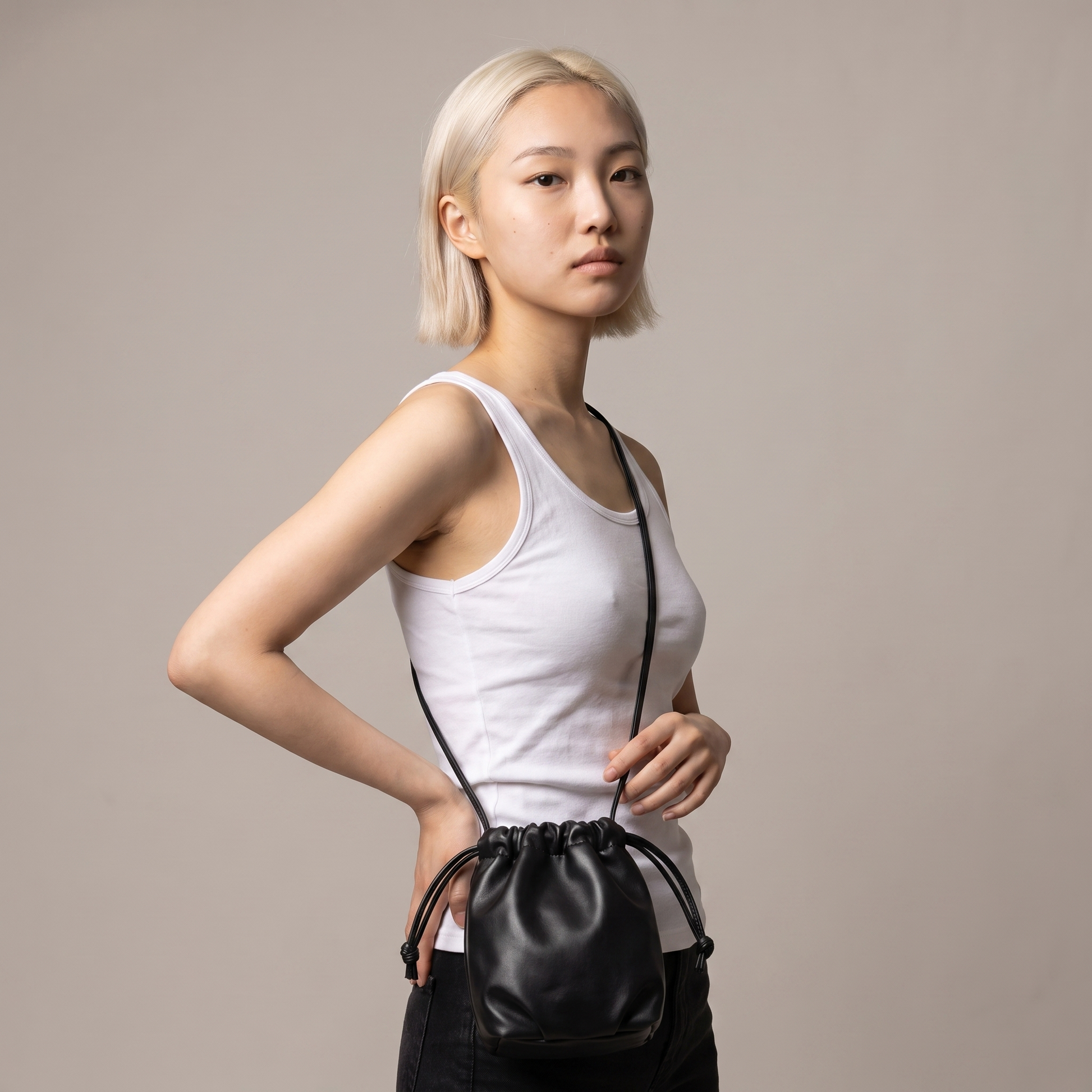 Sunoire mira black drawstring bucket bag worn detail 01