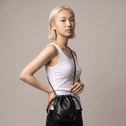 Sunoire mira black drawstring bucket bag worn detail 01
