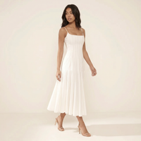 Sunoire white pleated cotton godet midi dress walking 01